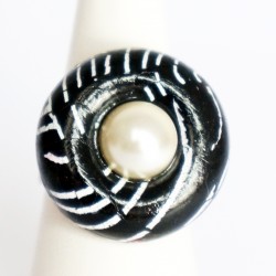 Black ring with white mother-of-pearl cabochon.