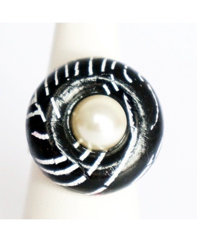 Black ring with white mother-of-pearl cabochon.