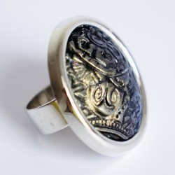 Large black ring with metallic reliefs