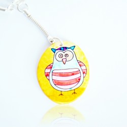 Blue and red owl keychain on a yellow background