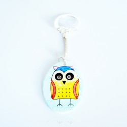 Yellow owl keychain on a sky blue background