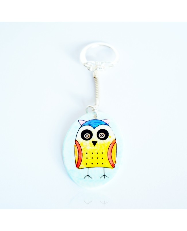 Yellow owl keychain on a sky blue background