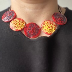 Red necklace with yellow and black scribbles