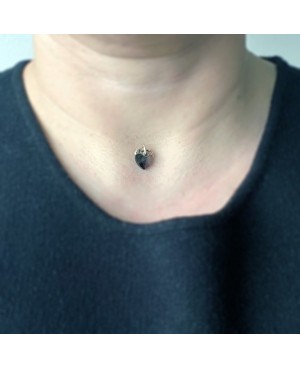 A small black heart pendant with a nylon cord Heart pendants